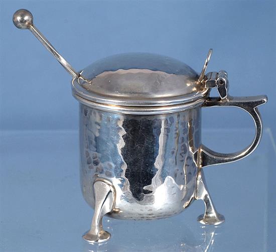 A George V Arts & Crafts silver three piece condiment set,